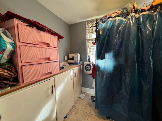 clothes washing area featuring light tile patterned flooring