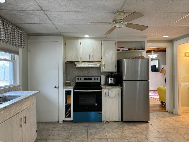 kitchen featuring appliances with stainless steel finishes, light tile patterned floors, extractor fan, and ceiling fan