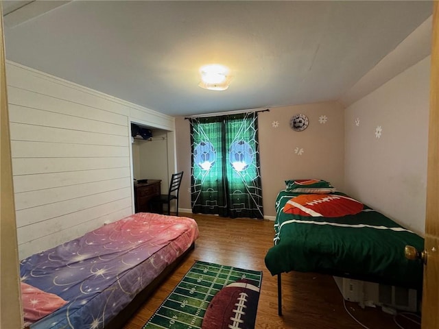 bedroom with dark hardwood / wood-style flooring