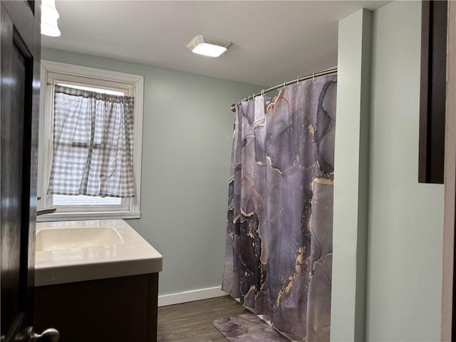 bathroom with vanity and hardwood / wood-style flooring