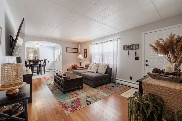 living room featuring wood-type flooring and baseboard heating