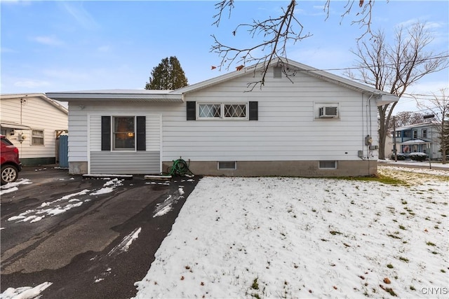 rear view of property featuring a wall mounted AC