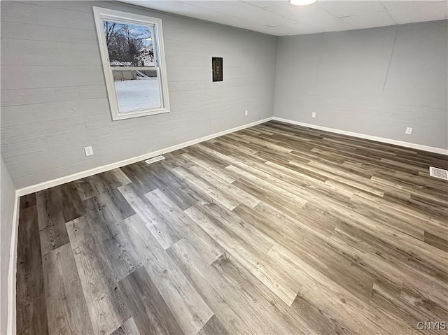 unfurnished room featuring hardwood / wood-style flooring