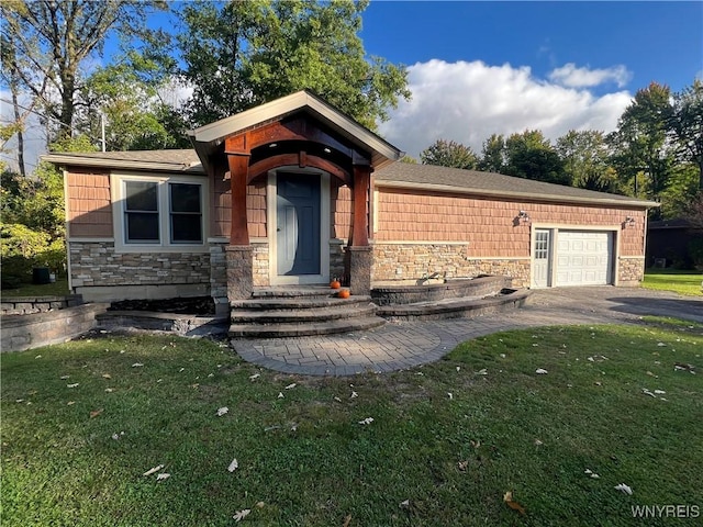 view of front of property with a front yard and a garage