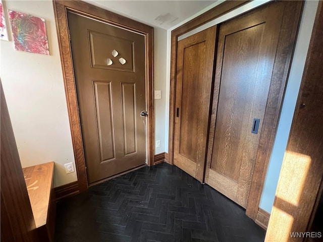 doorway with dark parquet floors