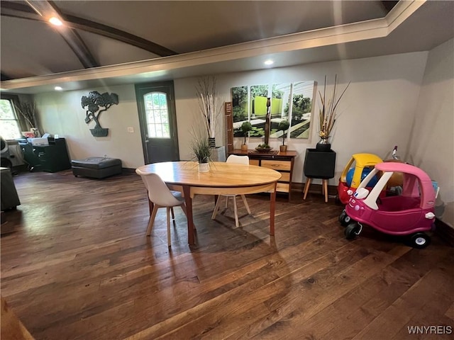 dining space with beamed ceiling, dark hardwood / wood-style flooring, and plenty of natural light