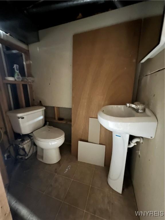 bathroom with tile patterned floors and toilet