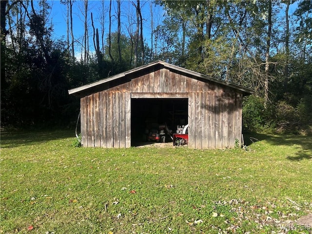 view of outdoor structure featuring a lawn