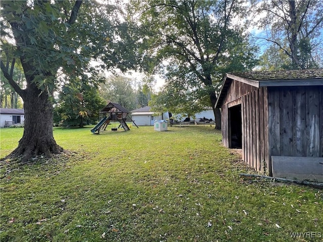 view of yard featuring an outdoor structure and a playground