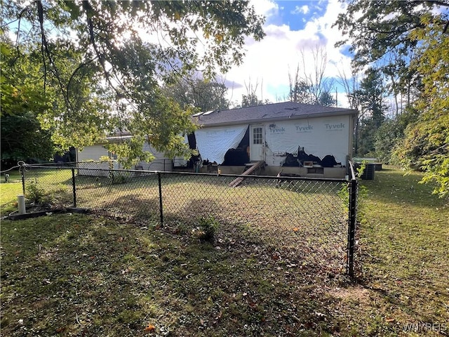 rear view of house featuring a lawn