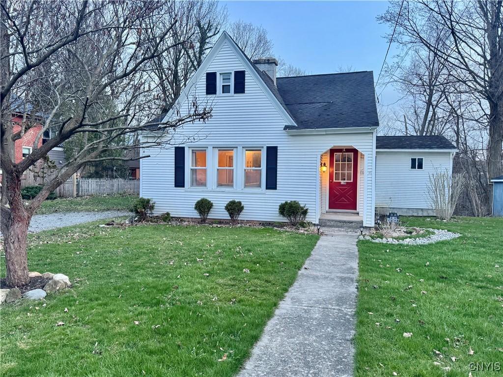 139 Owasco St, Auburn, NY 13021 - bungalow featuring a chimney, a shingled roof, fence, and a front lawn