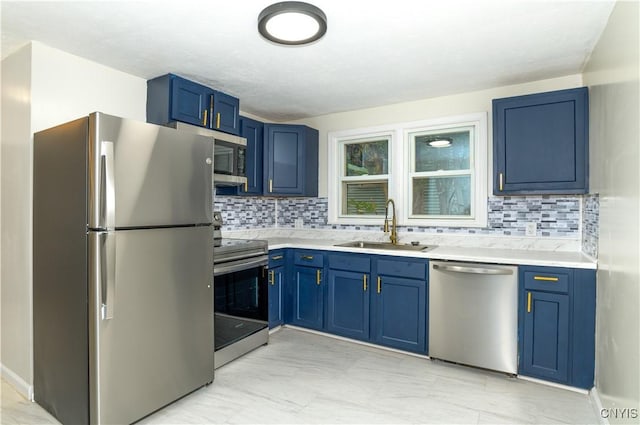 kitchen featuring decorative backsplash, sink, blue cabinets, and appliances with stainless steel finishes