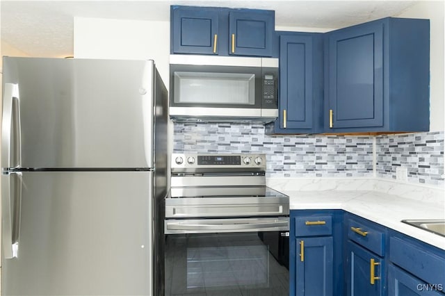 kitchen with light stone countertops, blue cabinets, a textured ceiling, decorative backsplash, and appliances with stainless steel finishes