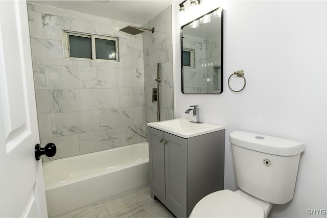 full bathroom with vanity, toilet, and tiled shower / bath