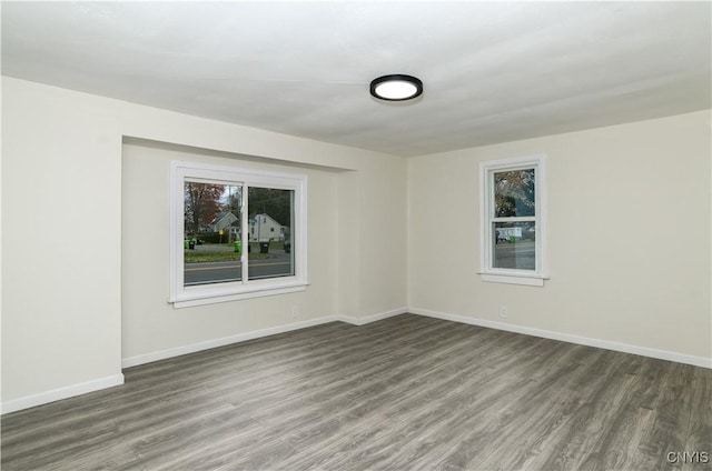 spare room with dark wood-type flooring