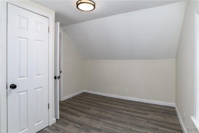 bonus room featuring dark hardwood / wood-style floors and vaulted ceiling