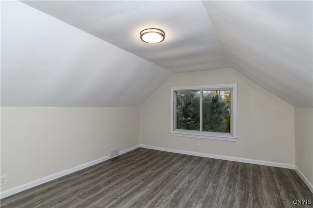 bonus room with dark hardwood / wood-style flooring and lofted ceiling