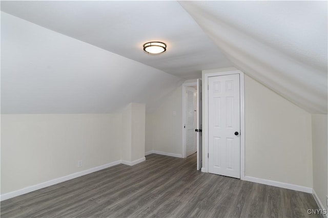 additional living space with dark hardwood / wood-style floors and lofted ceiling