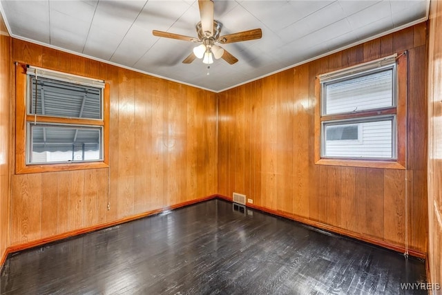 unfurnished room with wooden walls, dark hardwood / wood-style flooring, and ceiling fan