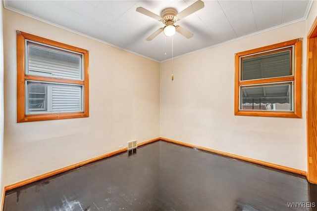 spare room with ceiling fan and ornamental molding