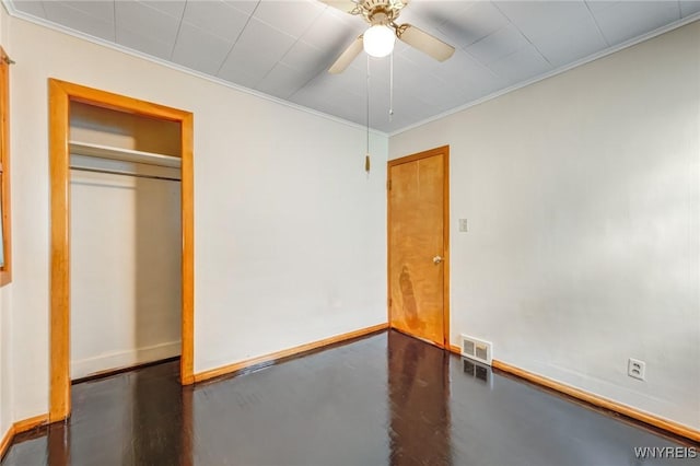 unfurnished bedroom featuring ceiling fan, ornamental molding, and a closet