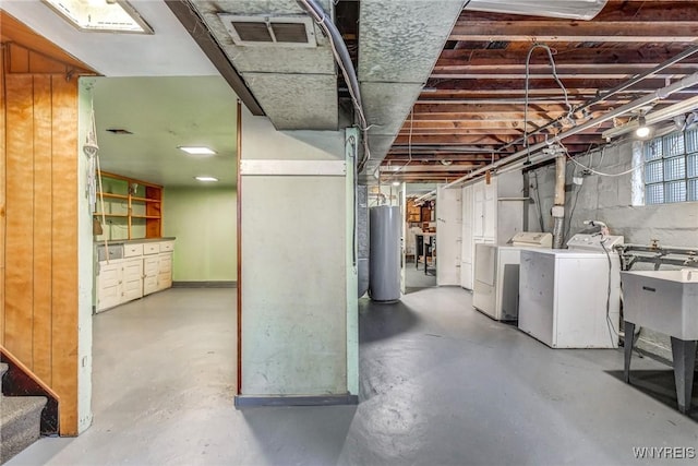 basement featuring separate washer and dryer and water heater