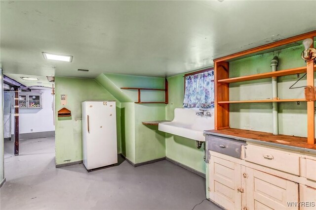 interior space with white fridge and sink