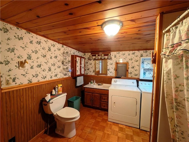 bathroom featuring vanity, toilet, washing machine and dryer, parquet flooring, and wood ceiling