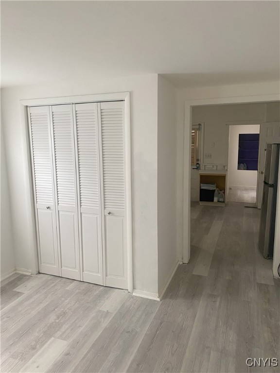 corridor with light hardwood / wood-style floors