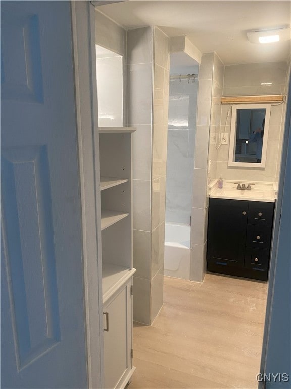 bathroom featuring shower / tub combination, vanity, and hardwood / wood-style flooring