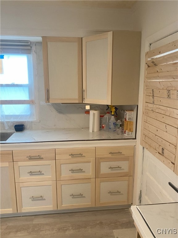 kitchen featuring cream cabinets and light hardwood / wood-style flooring