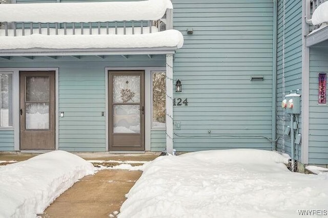 view of snow covered property entrance