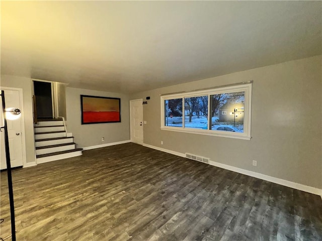 unfurnished living room with dark hardwood / wood-style floors