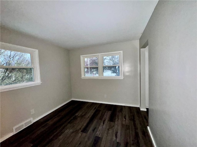 unfurnished room with dark hardwood / wood-style floors