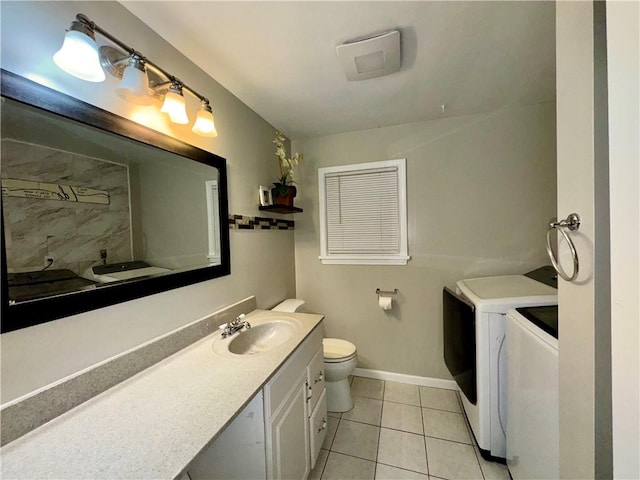 bathroom with washing machine and dryer, tile patterned flooring, vanity, and toilet