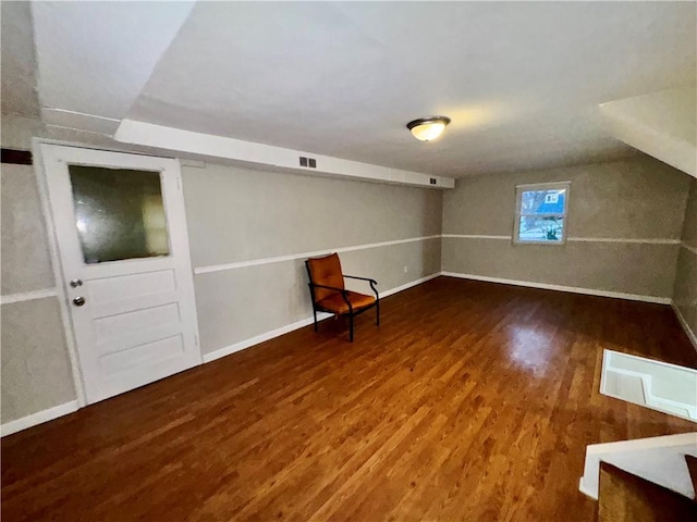 additional living space featuring hardwood / wood-style floors