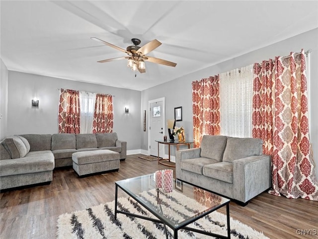 living room with ceiling fan and hardwood / wood-style flooring