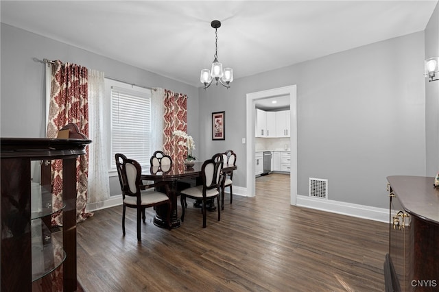 dining space featuring a notable chandelier and dark wood-type flooring