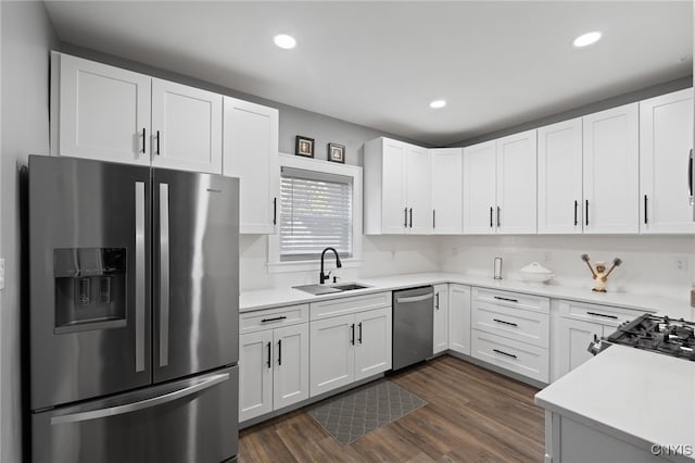 kitchen featuring white cabinets, dark hardwood / wood-style floors, sink, and appliances with stainless steel finishes