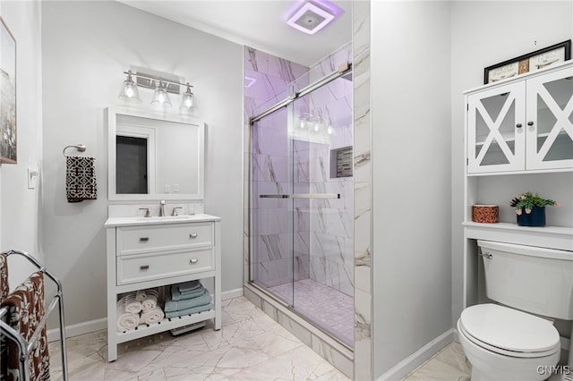 bathroom featuring vanity, toilet, and walk in shower