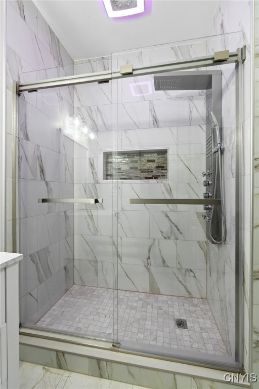 bathroom featuring vanity and an enclosed shower