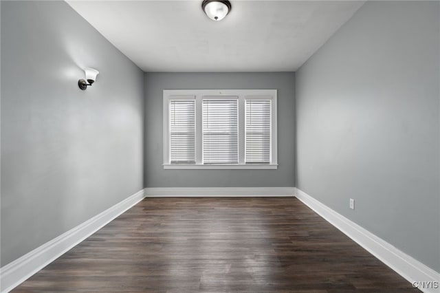 empty room with dark hardwood / wood-style flooring