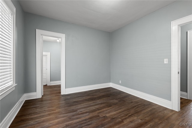 unfurnished room with dark hardwood / wood-style floors