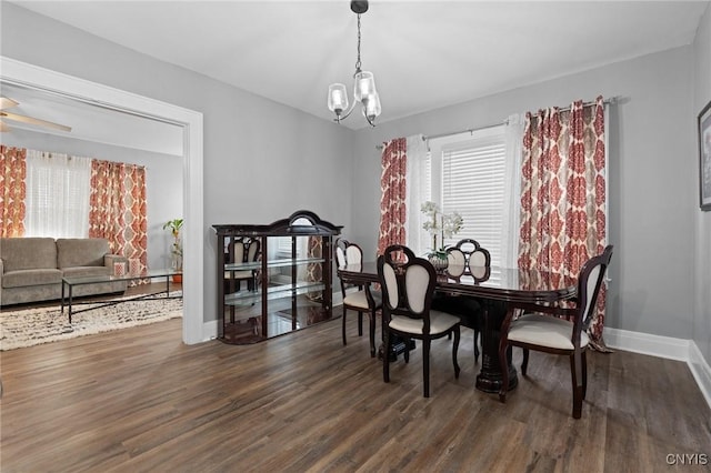 dining area with a chandelier and dark wood-type flooring