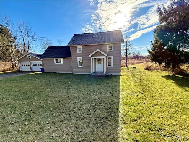 view of front of property featuring a front lawn, an outdoor structure, and a garage