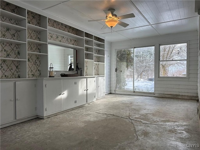 interior space with white cabinets and ceiling fan