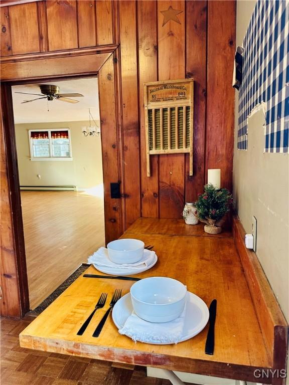 dining room with ceiling fan and baseboard heating