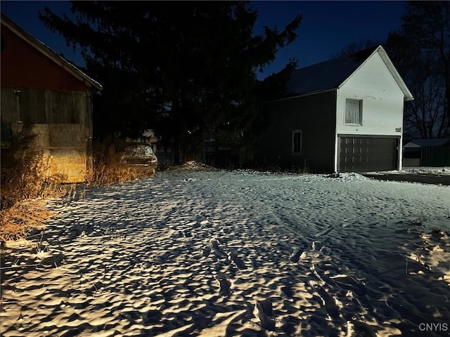 yard at twilight featuring a garage