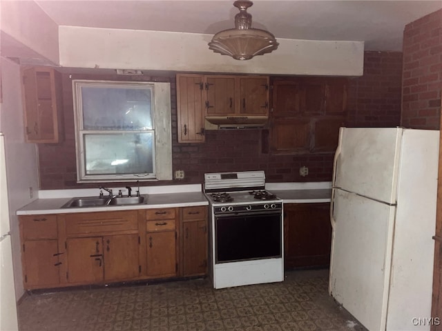 kitchen featuring white appliances and sink