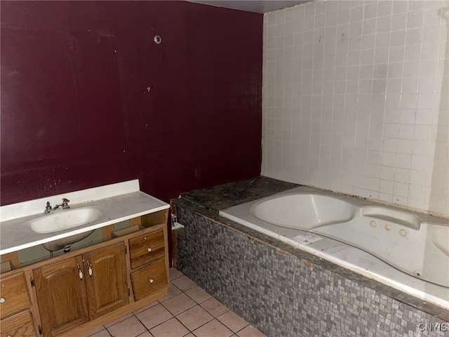 bathroom featuring tile patterned flooring, vanity, and a relaxing tiled tub